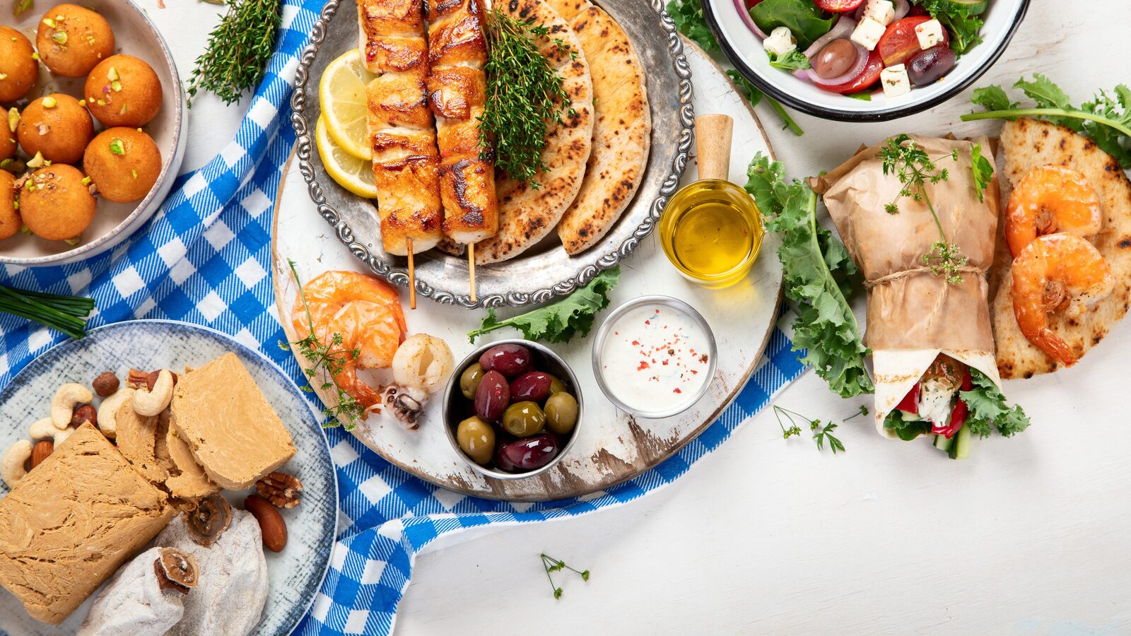 A table spread of Greek meze, salad, tzatziki and grilled seafood in Athens
