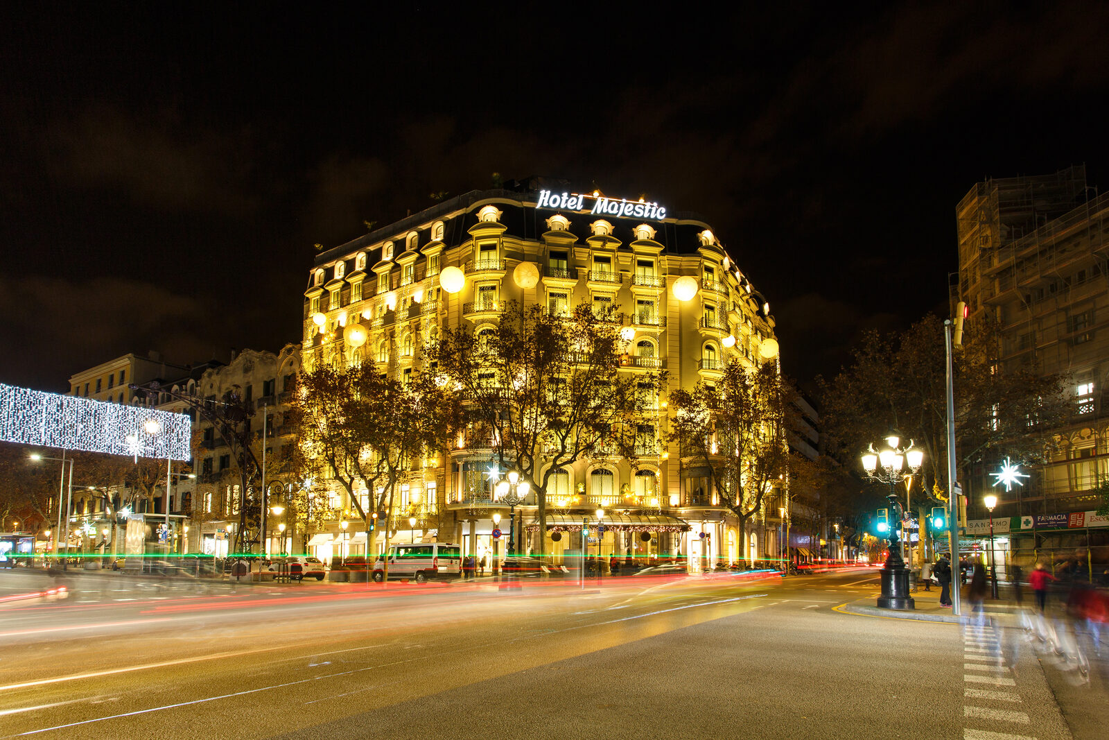 A luxury rooftop terrace overlooking the Barcelona skyline at dusk