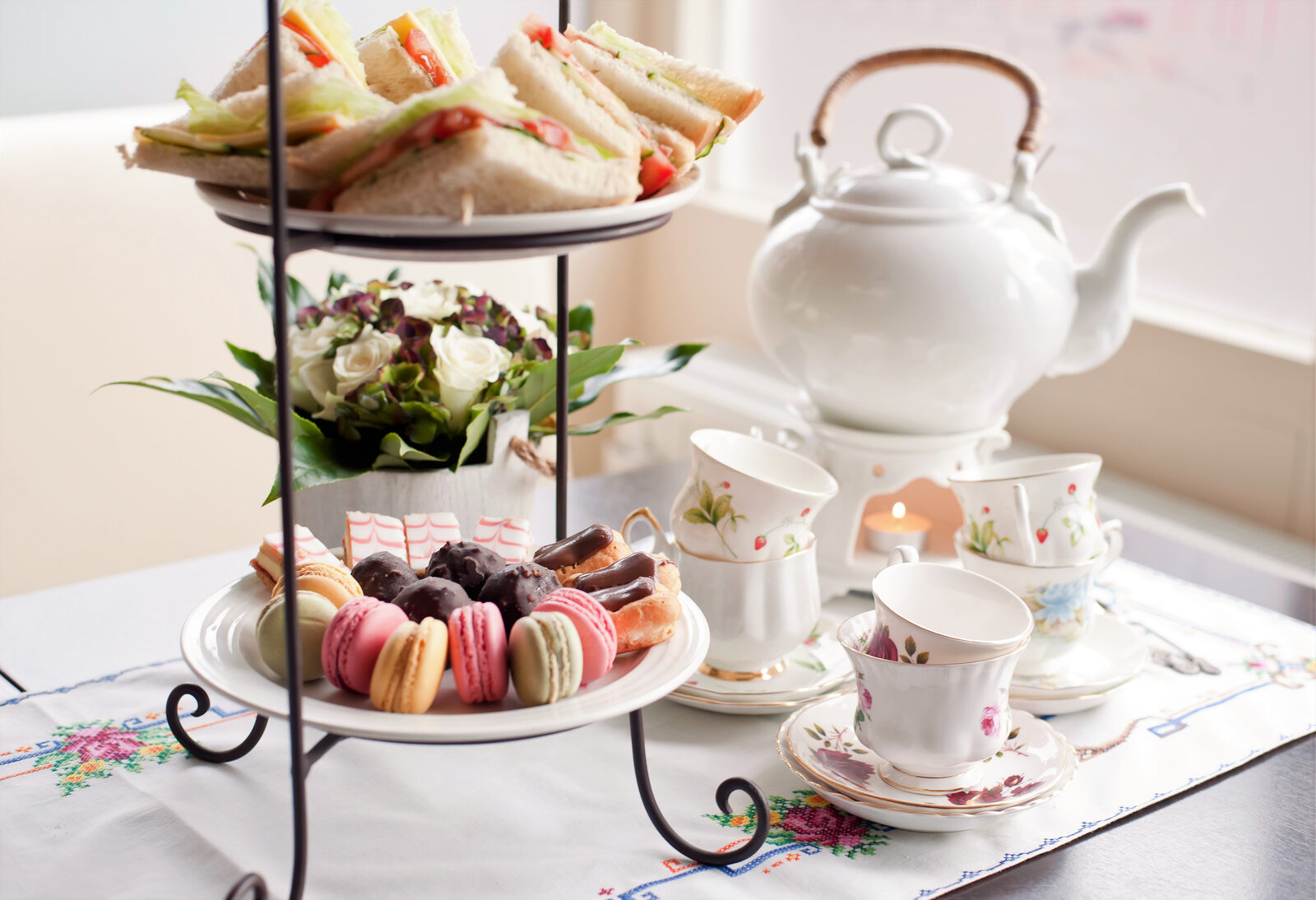 A tiered stand of sandwiches, scones, and pastries set for afternoon tea in London