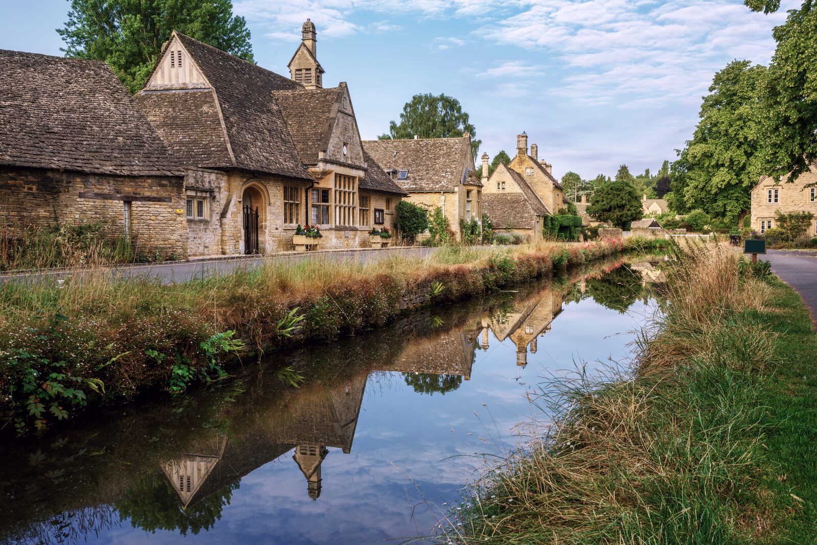 A village of golden limestone cottages in the Cotswolds countryside
