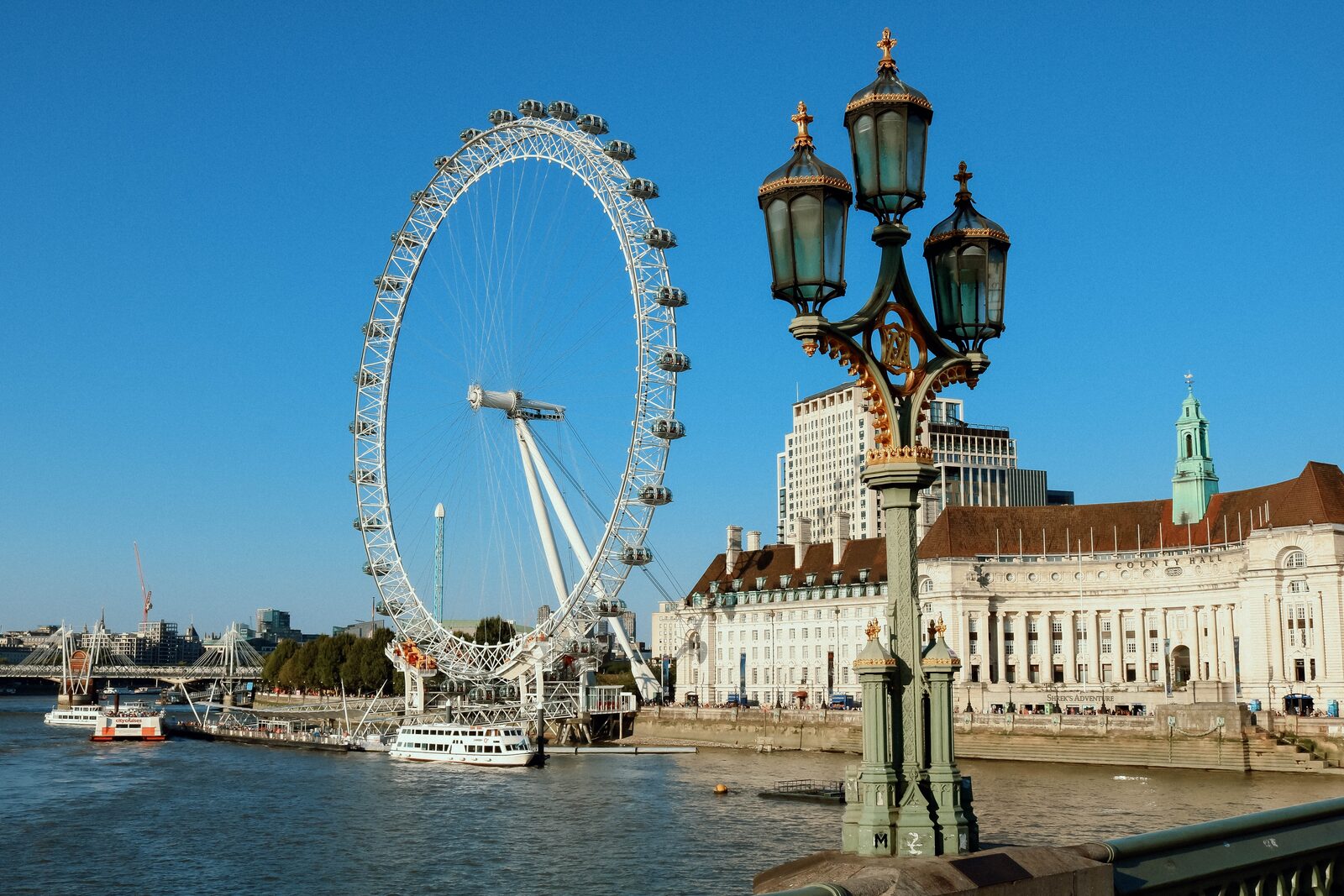 The London Eye observation wheel beside the River Thames at dusk