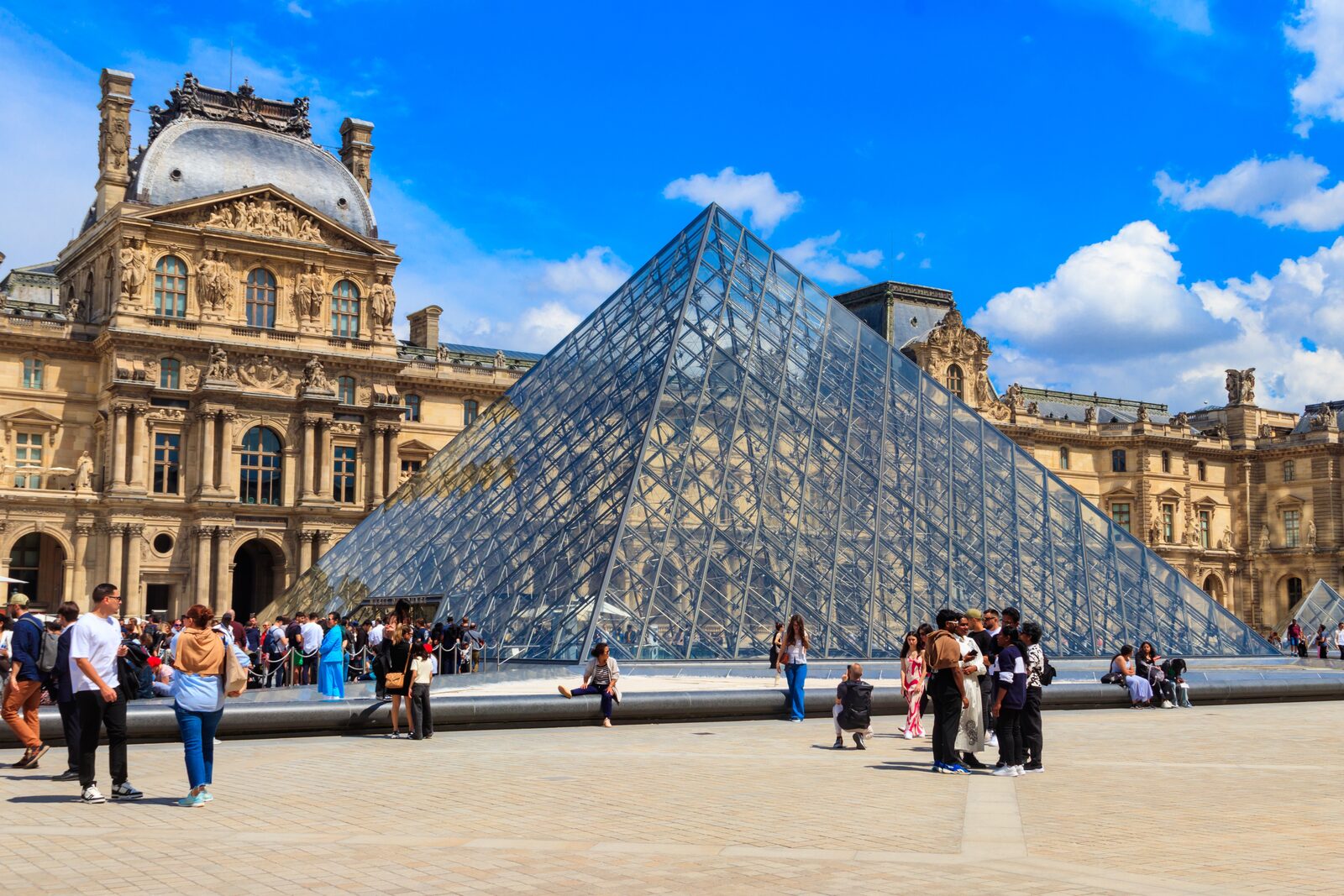 The glass pyramid and palace wings of the Louvre in Paris