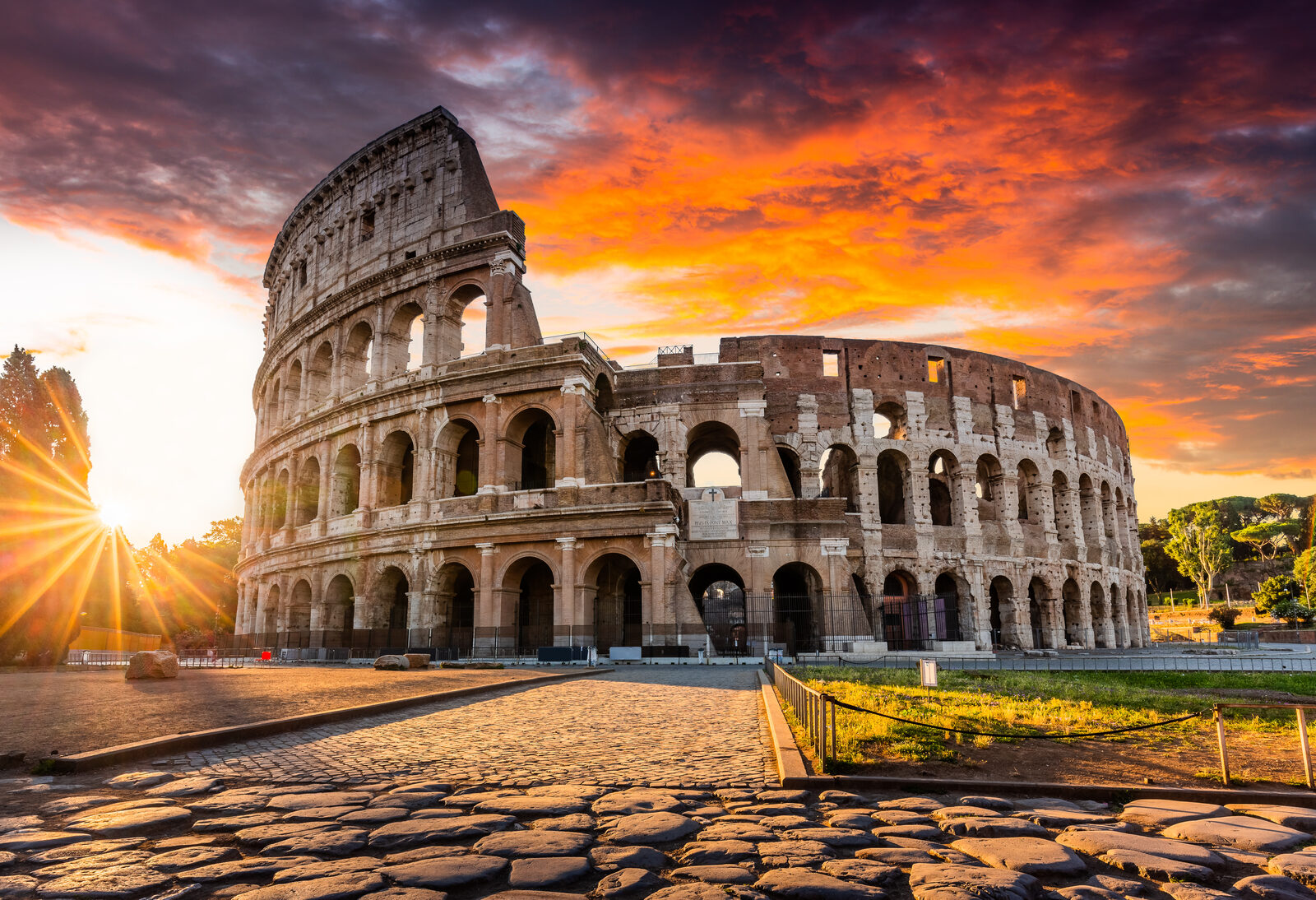 The ancient Colosseum amphitheater glowing at golden hour in Rome
