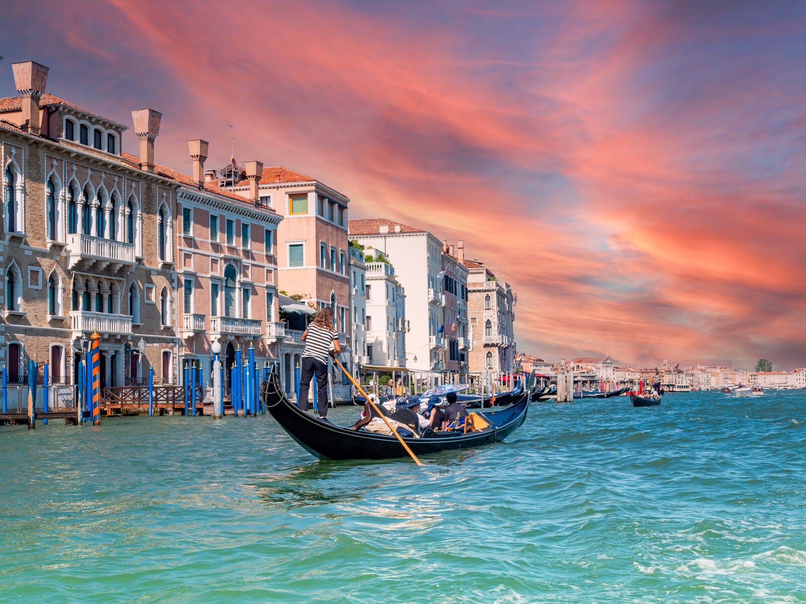 A gondola on the Grand Canal lined with historic palaces in Venice